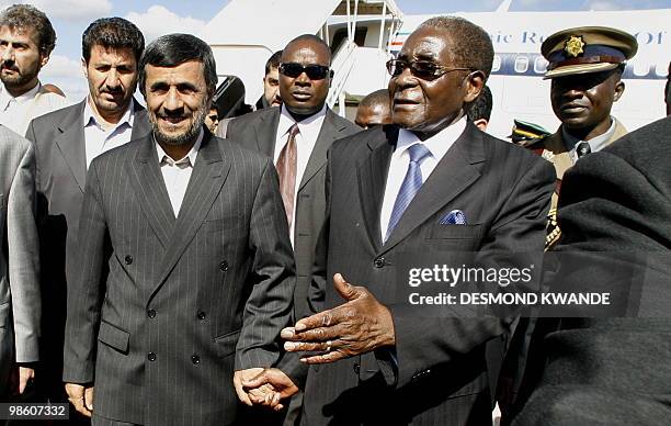 Zimbabwean president Robert Mugabe welcomes Iranian President Mahmoud Ahmadinejad at Harare Airport on April 22, 2010. Iran's President Mahmoud...