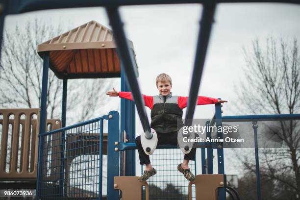 boy playin on jungle gym - jungle gym ストックフォトと画像