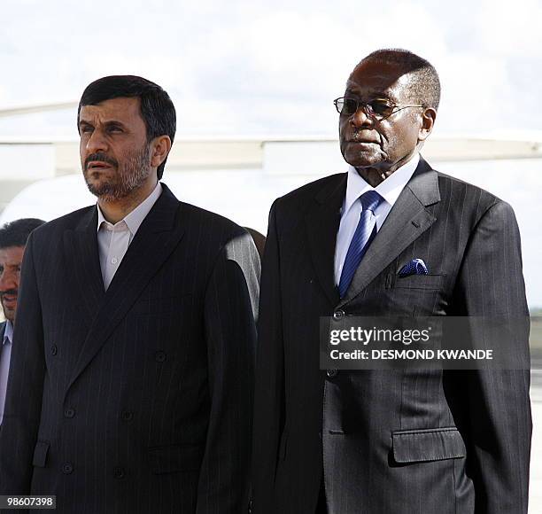 Zimbabwean president Robert Mugabe welcomes Iranian President Mahmoud Ahmadinejad at Harare Airport on April 22, 2010. Iran's President Mahmoud...