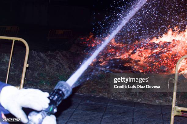 2018 festivities of saint juan - fireman fighting fire - silva v diaz stockfoto's en -beelden