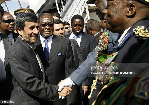 Zimbabwe's President Robert Mugabe introduces Iranian President Mahmoud Ahmadinejad to unidentified Zimbabwean army chiefs soon after his arrival at...