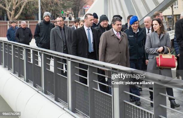 German Foreign Minister Sigmar Gabriel walks next to Nataliya Apostolova , European Union Special Representative in Kosovo, across the symbolically...