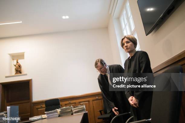 Maike Kohl-Richter and her lawyer Thomas Hermes stand in a courtroom of the Higher Regional Court in Cologne, Germany, 15 February 2018. The legal...