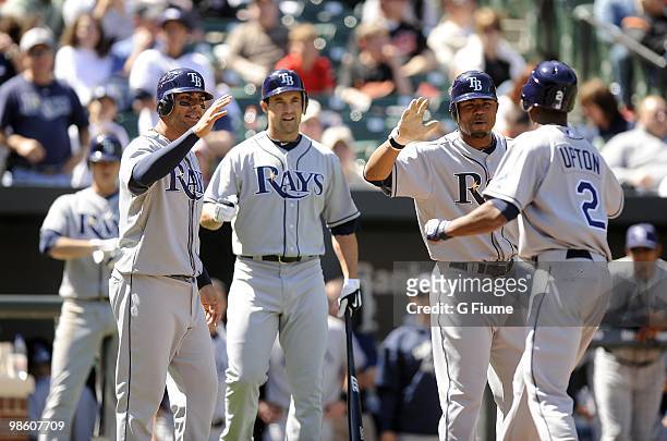 Upton of the Tampa Bay Rays is congratulated by Carlos Pena, Pat Burrell and Carl Crawford after hitting a home run against the Baltimore Orioles on...