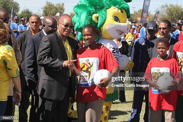 South African President Jacob Zuma shakes hands with a young soccer player during celebrations marking the 50 Day Countdown to the start of the FIFA...