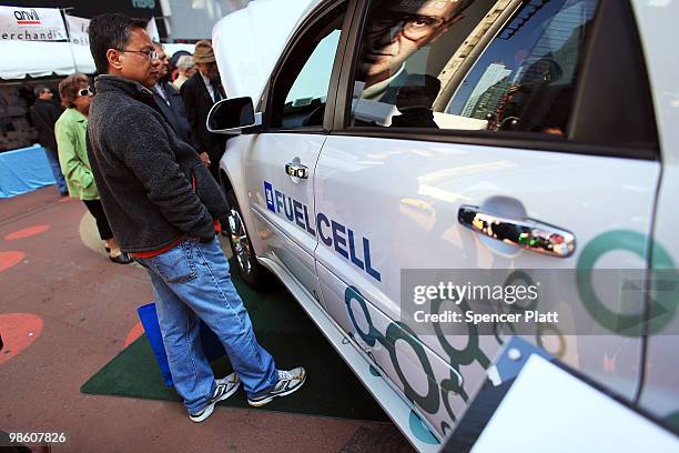 Man looks at a new Chevy Equinox Fuel Cell car that will go 200 miles per fill up at an Earth Day event in Times Square on April 22, 2010 in New York...