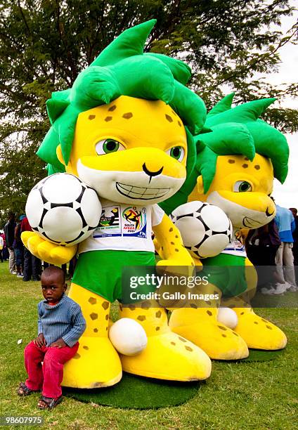 Young boy takes a rest on mascot Zakumi's big foot during celebrations marking the 50 Day Countdown to the start of the FIFA 2010 World Cup on April...