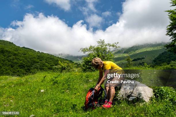 senior woman hiking in julian alps in spring, primorska, slovenia, europe - pavliha stock pictures, royalty-free photos & images