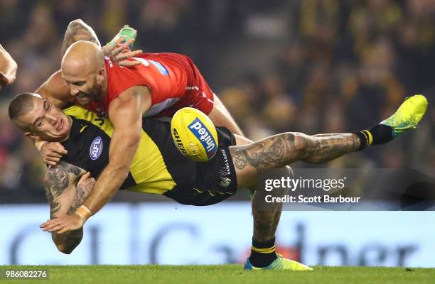 Jarrad McVeigh of the Swans is tackled by Dustin Martin of the Tigers during the round 15 AFL match between the Richmond Tigers and the Sydney Swans...