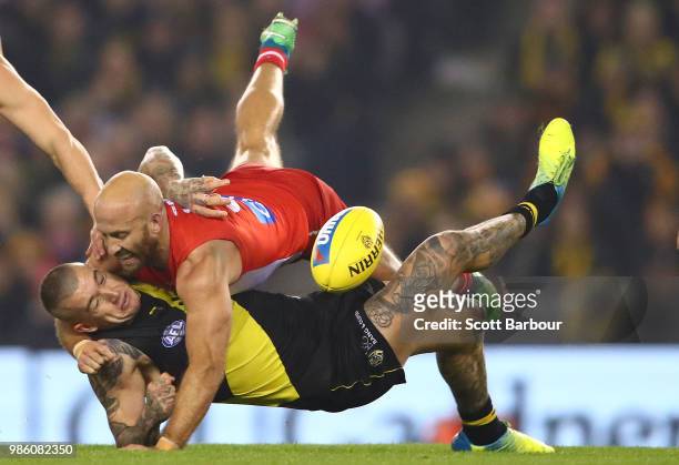 Jarrad McVeigh of the Swans is tackled by Dustin Martin of the Tigers during the round 15 AFL match between the Richmond Tigers and the Sydney Swans...