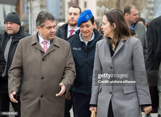 German Foreign Minister Sigmar Gabriel walks next to Nataliya Apostolova, European Union Special Representative in Kosovo, across the symbolically...
