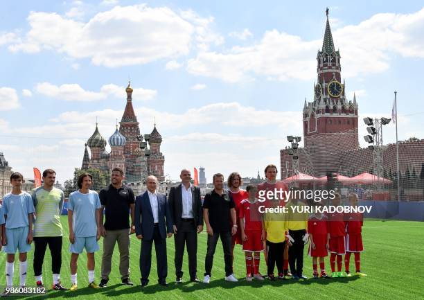 Russia's President Vladimir Putin and FIFA President Gianni Infantino pose for a picture with Russia's Football Union's anti-racism inspector Alexei...