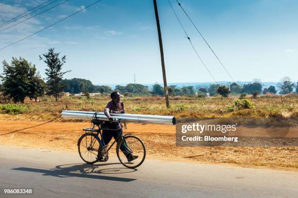 Cyclist transports metalwork along a road in Lilongwe, Malawi, on Tuesday, June 26 2018. The diversification of the agriculture-reliant economy is a...