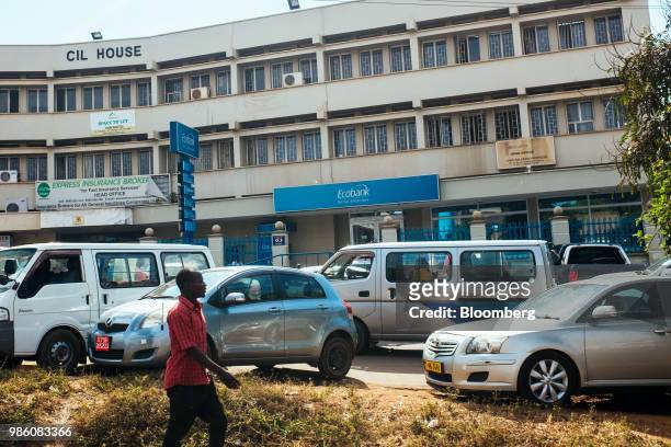 Pedestrian passes a bank branch of Ecobank Nigeria Ltd. In Lilongwe, Malawi, on Tuesday, June 26 2018. The diversification of the agriculture-reliant...