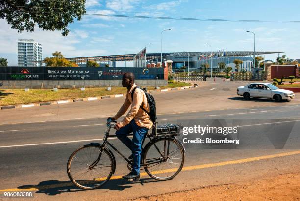 Cyclist passes the Bingu Wa Mutharika International Convention Centre in Lilongwe, Malawi on Tuesday, June 26 2018. The diversification of the...