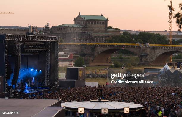 June 2018, Germany, Dresden: Numerous people attend the concert of 'Queens of the Stone Age' at the 'Koenigsufer'. The concert inaugurates Dresden's...