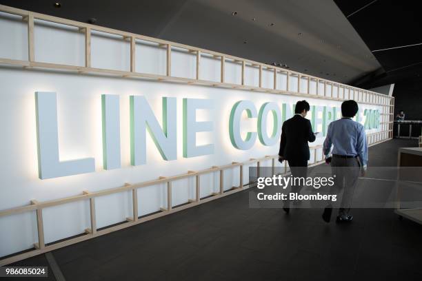 Attendees walk past 'LINE Conference 2018' signage in Urayasu, Chiba prefecture, Japan, on Thursday, June 28, 2018. Line, Japans biggest messaging...