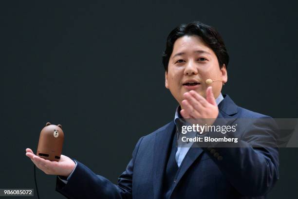 Jun Masuda, chief strategy & marketing officer of LINE Corp., holds the company's Clova Friends Mini smart speaker as he speaks during the company's...