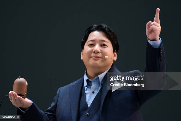 Jun Masuda, chief strategy & marketing officer of LINE Corp., holds the company's Clova Friends Mini smart speaker as he speaks during the company's...
