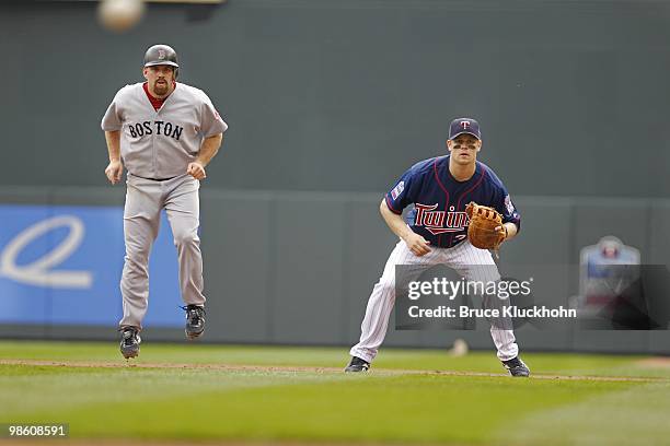 April 14: Kevin Youkilis of the Boston Red Sox and Justin Morneau of the Minnesota Twins await the pitch on April 14, 2010 at Target Field in...