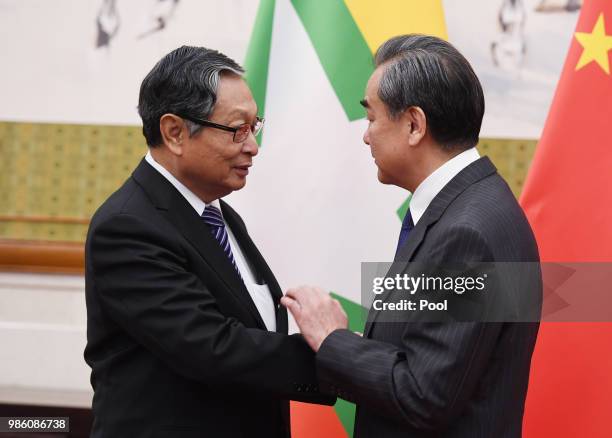 Chinese Foreign Minister Wang Yi shakes hands with Myanmar's Minister of the Office of the State Counsellor Kyaw Tint Swe at the Diaoyutai State...