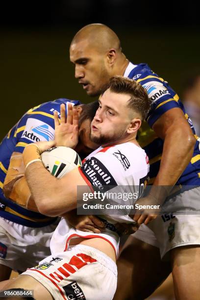 Jacob Host of the Dragons is tackled during the round 16 NRL match between the St George Illawarra Dragons and the Parramatta Eels at WIN Stadium on...