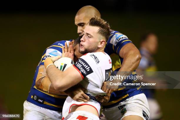 Jacob Host of the Dragons is tackled during the round 16 NRL match between the St George Illawarra Dragons and the Parramatta Eels at WIN Stadium on...