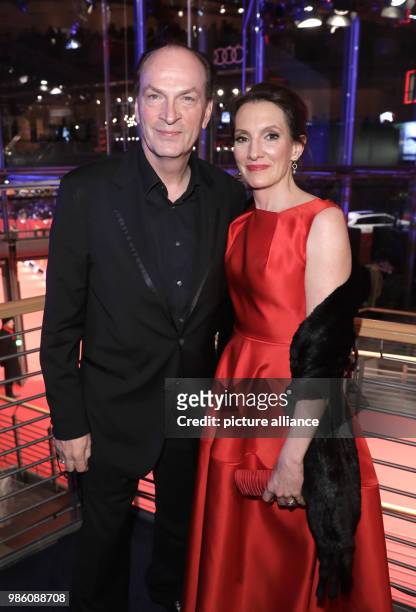 Actor Herbert Knaup hand his wife Christiane Knaup attend the opening party of the 68th International Berlin Film Festival in Berlin, Germany, 15...