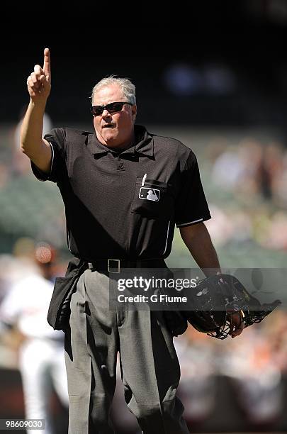 Home plate umpire Tim Welke signals for one more warm up pitch during the game between the Baltimore Orioles and the Tampa Bay Rays on April 14, 2010...