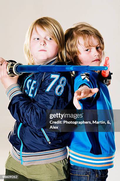 boys with laser swords. - toy sword stock pictures, royalty-free photos & images