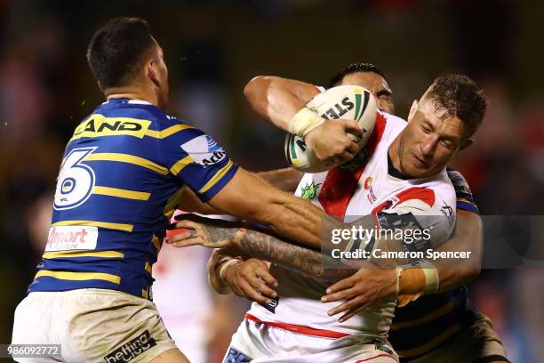 Tariq Sims of the Dragons is tackled during the round 16 NRL match between the St George Illawarra Dragons and the Parramatta Eels at WIN Stadium on...