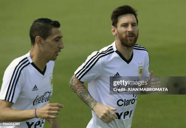 Argentina's forwards Lionel Messi and Angel Di Maria jog during a training session at the team's base camp in Bronnitsy, near Moscow, on June 28...