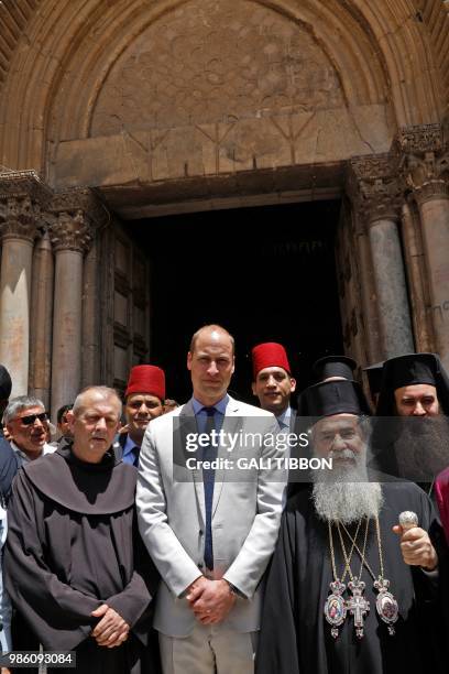 Britain's Prince William stands in front of the Church of the Holy Sepulchre with the Greek Orthodox Patriarch of Jerusalem Theophilos III and...