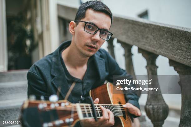 man with differing abilities playing acoustic guitar - soloist stock pictures, royalty-free photos & images