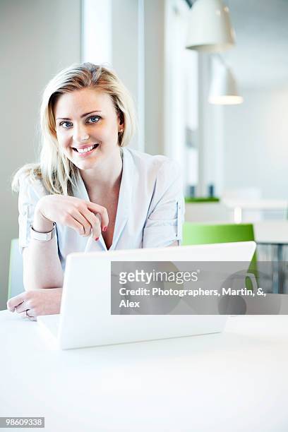 blond woman using a laptop, sweden. - ウップランド ストックフォトと画像