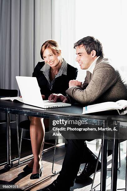 two businesspeople having by a laptop, sweden. - ウップランド ストックフォトと画像