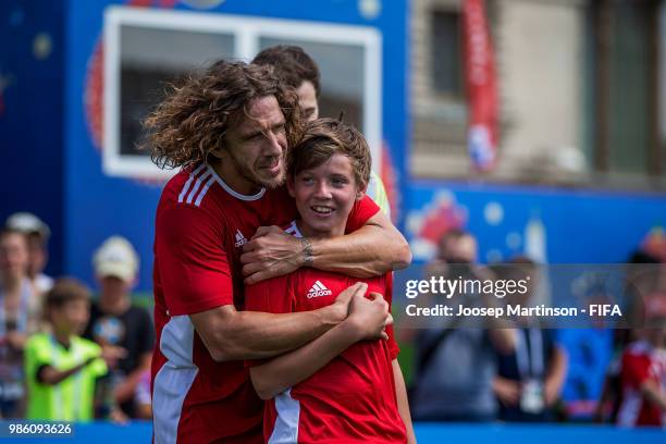 Carles Puyol hugs his team mate during a Football Event at Red Square on June 28, 2018 in Moscow, Russia.