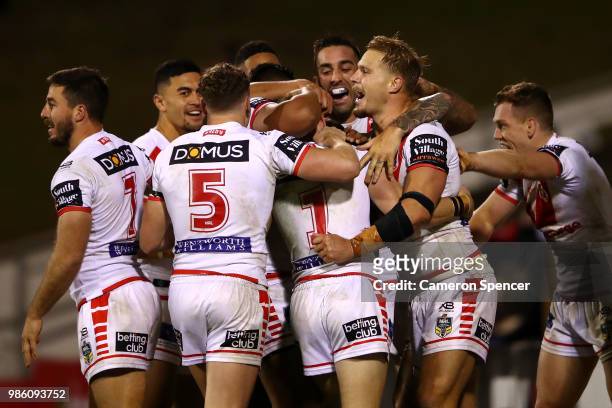 Matt Dufty of the Dragons celebrates with team mates after scoring the winning try during the round 16 NRL match between the St George Illawarra...