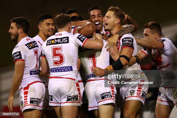 Matt Dufty of the Dragons celebrates with team mates after scoring the winning try during the round 16 NRL match between the St George Illawarra...