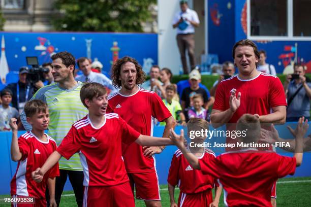 Iker Casillas, Carles Puyol and Dmitry Bulykin react with their team during a Football Event at Red Square on June 28, 2018 in Moscow, Russia.