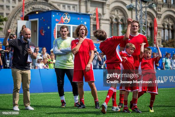 Iker Casillas, Carles Puyol and Dmitry Bulykin react with their team during a Football Event at Red Square on June 28, 2018 in Moscow, Russia.