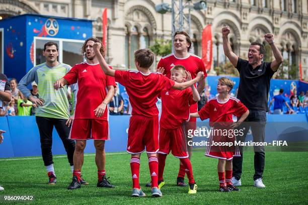 Iker Casillas, Carles Puyol, Dmitry Bulykin and Lothar Matthaus react with their team during a Football Event at Red Square on June 28, 2018 in...