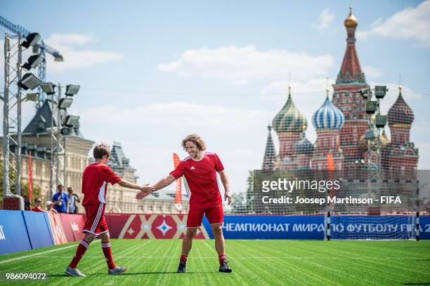 Carles Puyol high fives his team mate during a Football Event at Red Square on June 28, 2018 in Moscow, Russia.
