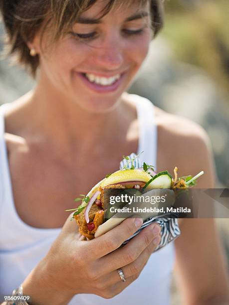 woman eating at a picnic, sweden. - falafel stock-fotos und bilder