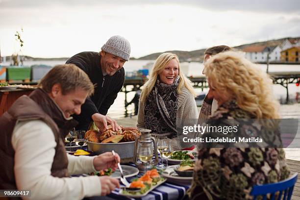 people at a dinner party outdoors, sweden. - crab feast stock pictures, royalty-free photos & images