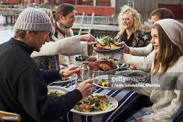 people at a dinner party outdoors, sweden. - eating seafood stock pictures, royalty-free photos & images