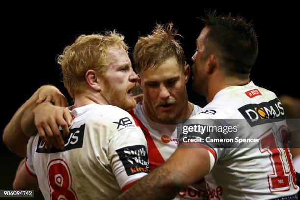 James Graham, Jack de Belin and Paul Vaughan of the Dragons celebrate winning the round 16 NRL match between the St George Illawarra Dragons and the...