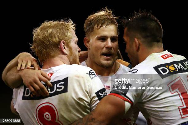 James Graham, Jack de Belin and Paul Vaughan of the Dragons celebrate winning the round 16 NRL match between the St George Illawarra Dragons and the...