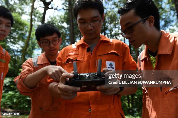 Thai oil companty PTT personnel prepares a thermal imaging drone in the moutain of Khun Nam Nang Non Forest Park in Chiang Rai province on June 28,...