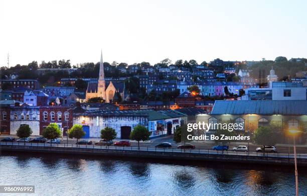 cork, ireland, at dusk, from across river lee. - river lee cork stock pictures, royalty-free photos & images